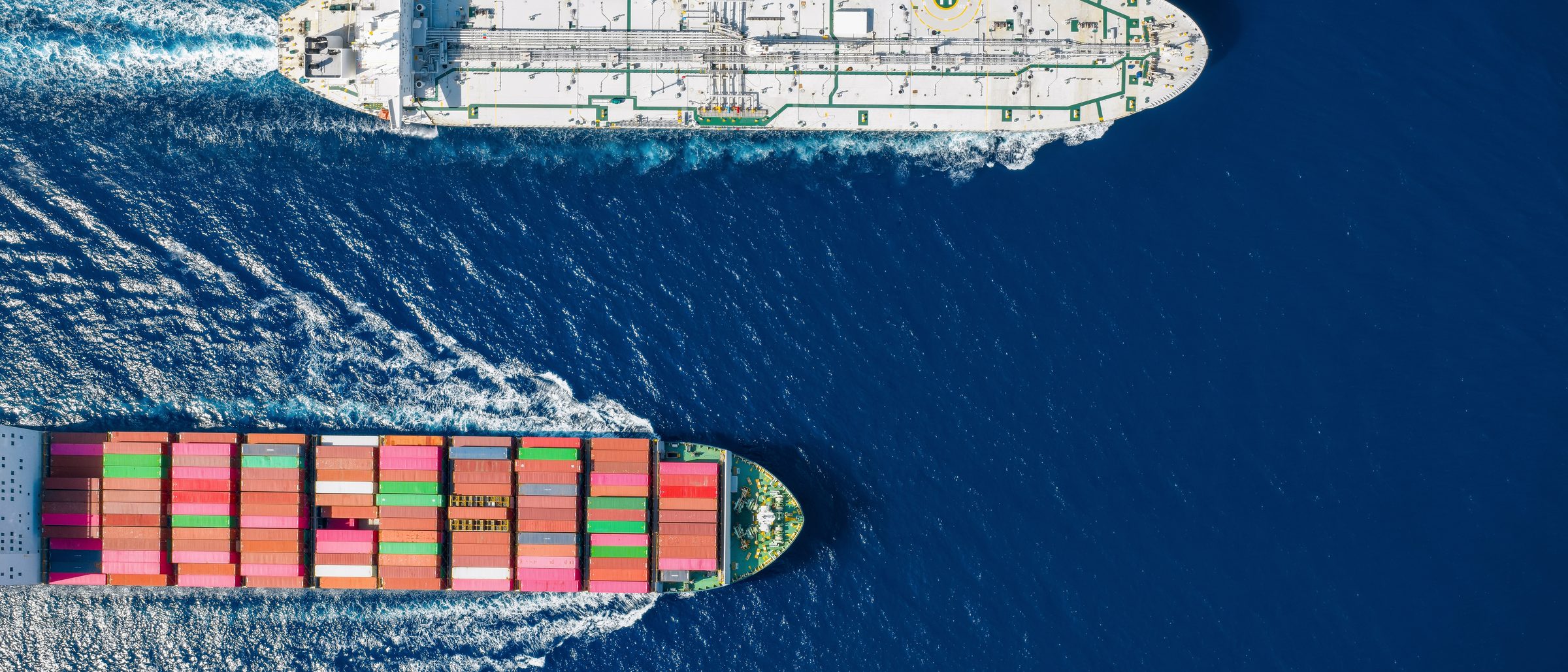 Aerial view of a tanker and container ship underway at sea