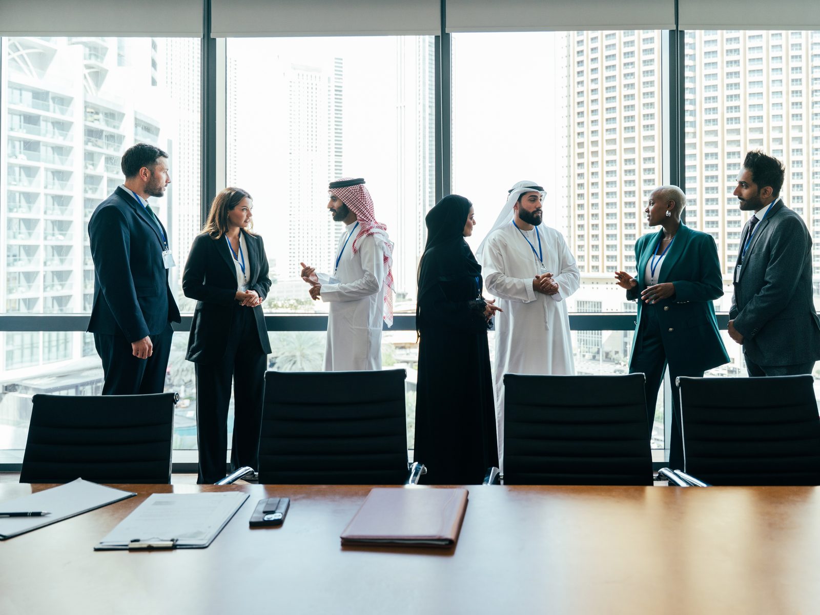Ozofryn team in discussion in a Dubai office overlooking the city skyline
